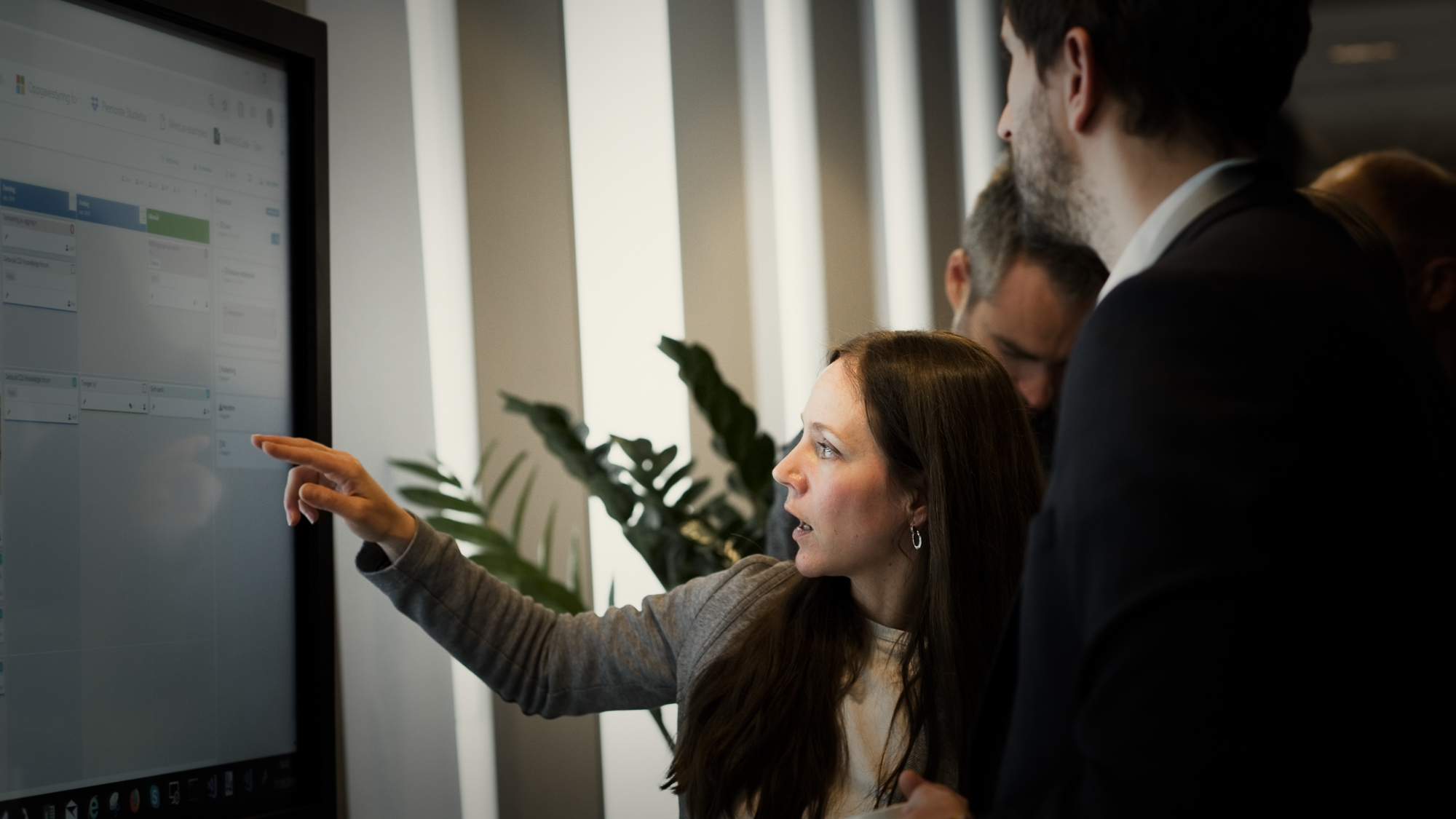 Woman presenting DigiLEAN for customer on a touch screen