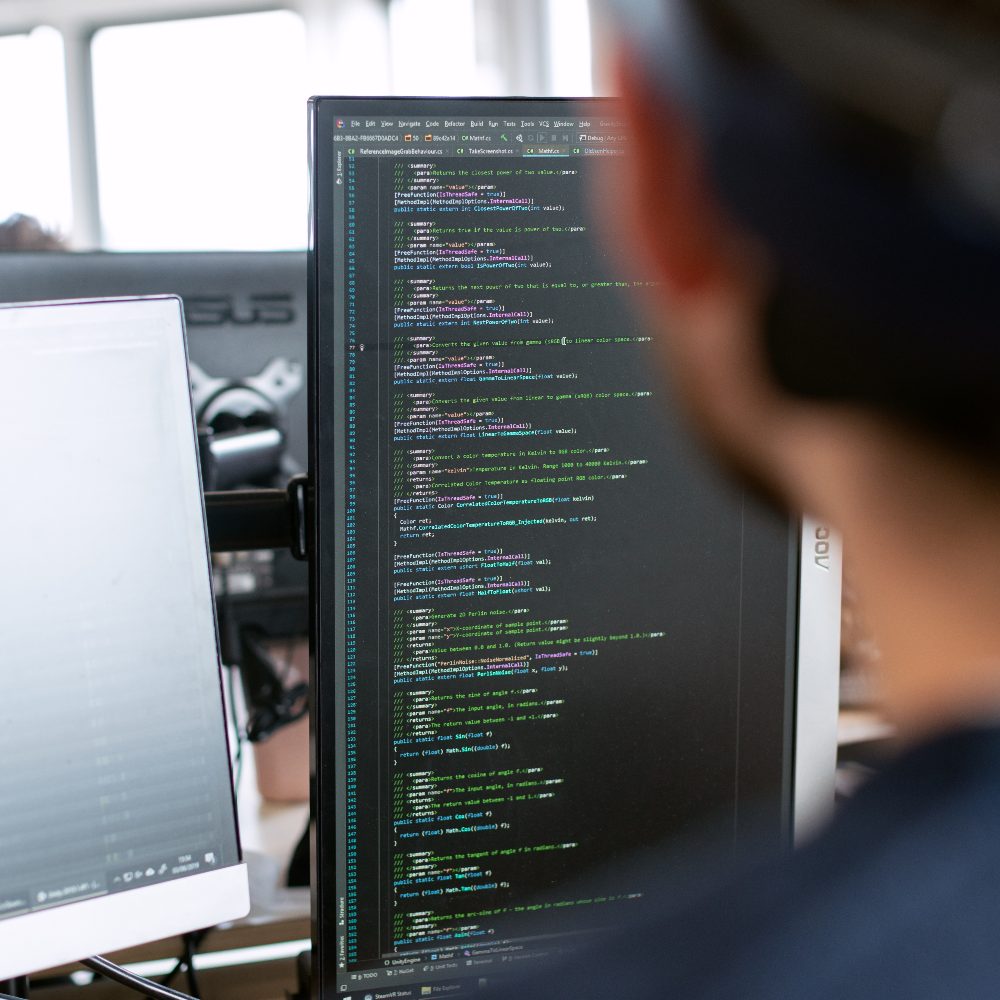 Man at work with programming code on his computer screen