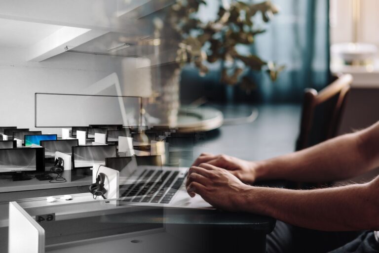 An empty office landscape fading into a single person with a laptop at home